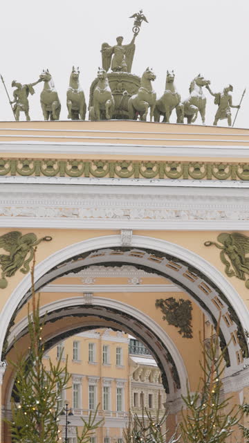 Arch of the General Staff on the central Palace square of the city during the snowfall, flag of Armed Forces