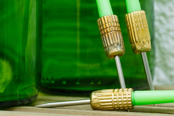 istock Green darts from a dartboard resting on beer bottles. 1914211053