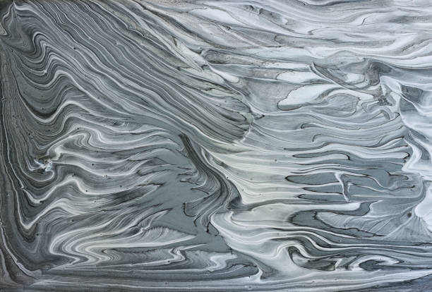 art photography of abstract marbleized effect background with black, gray and white creative colors. Beautiful paint.