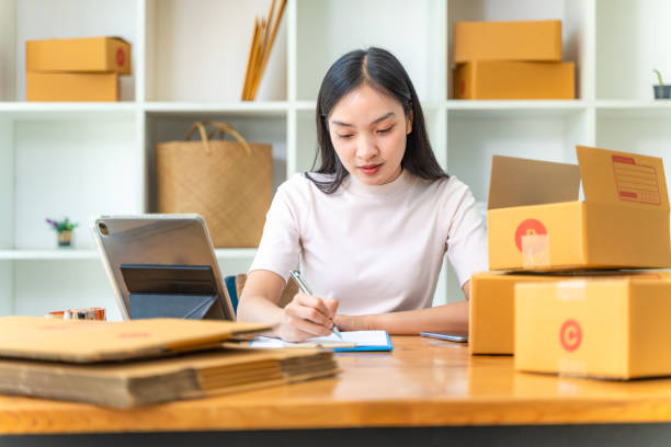 istock Happy young online businesswoman working at her home office writing down her plan on a notepad 1914216258