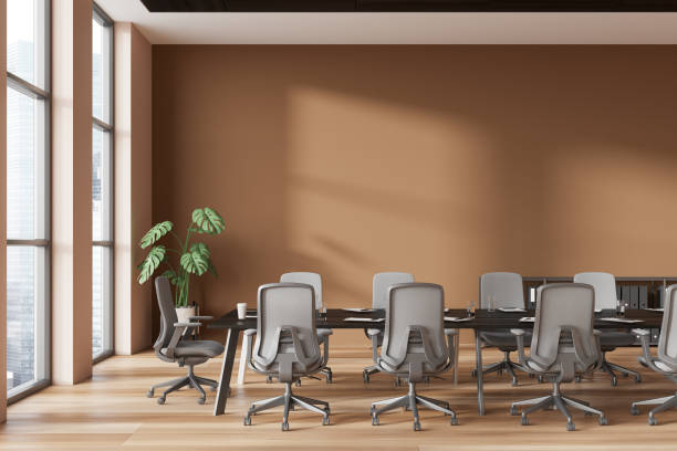 istock Brown office business room interior with meeting table and window, wall mock up 1914222593