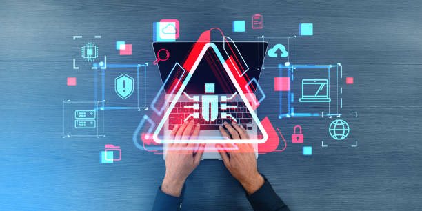 istock Man hands typing on laptop with bug and virus alert icons 1914231805