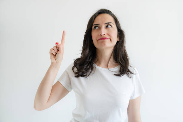 Beautiful woman pointing finger up