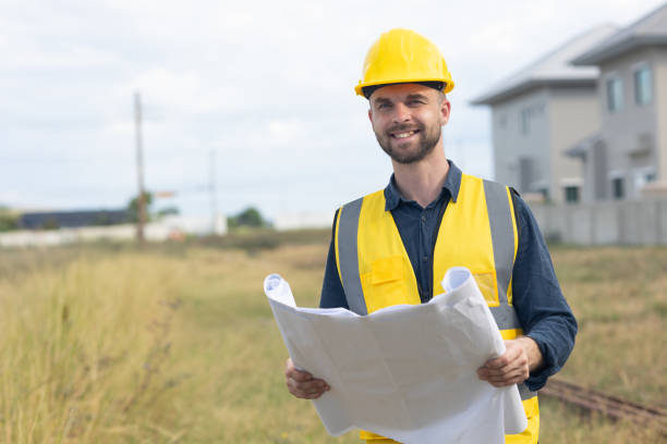 istock Professional construction worker engineer male. Real estate house project builder. Smart architect man standing work in construction site. 1914256325
