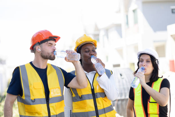 istock Healthy worker engineer team thirsty drinking clean water in hot temperature weather summer season for fresh relax at construction site workplace. 1914256333