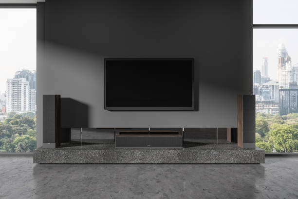 istock Grey living room interior with tv display with soundbar, panoramic window 1914279595