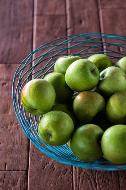 fresh and delicious green apples on an old table