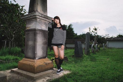 sad woman at graveyard