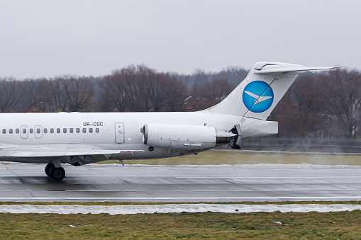 Close-up of a Ukrainian airline's Bravo Airways McDonnell Douglas MD-83 engine's reverse thrust while slowing down after landing in Lviv