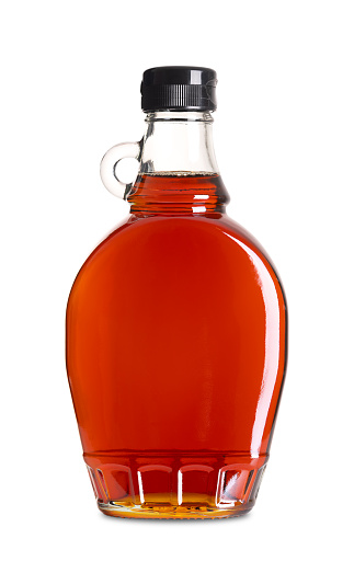 Maple syrup in a glass bottle. Bottled Canadian maple syrup made from the sap of maple trees in which sucrose is the most prevalent sugar. Used in baking, as condiment, sweetener and flavouring agent.