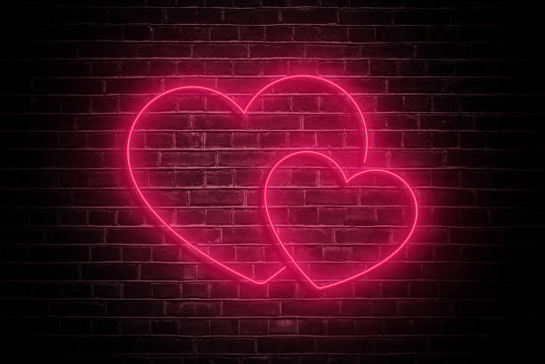 istock Neon Love: Valentine's Day Heart on Dark Brick Wall 1914364028