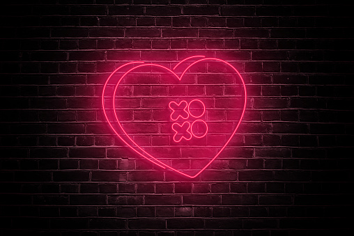 Illuminate your romance with the soft glow of a neon heart on a dark brick wall, casting a warm and intimate ambiance—a perfect visual ode to love on Valentine's Day