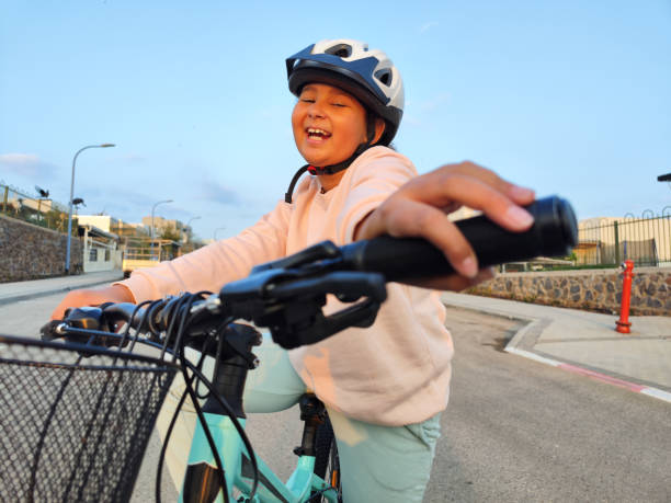istock Nine-year-old girl riding her bicycle. 1914380536