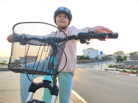 Close-up image of a Nine-year-old girl riding her bicycle.