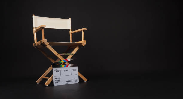 istock White director chair with clapper board on black background 1914413571