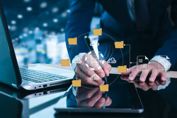 istock An IT specialist is configuring a laptop computer in the office to use the Document Management System (DMS). Software for preserving corporate files 1914437153