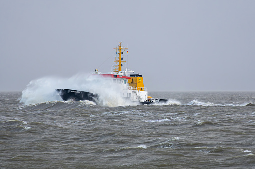 Cuxhaven, Germany - December 21, 2023: German water street authorities survey vessel Grimmershörn in rough seas