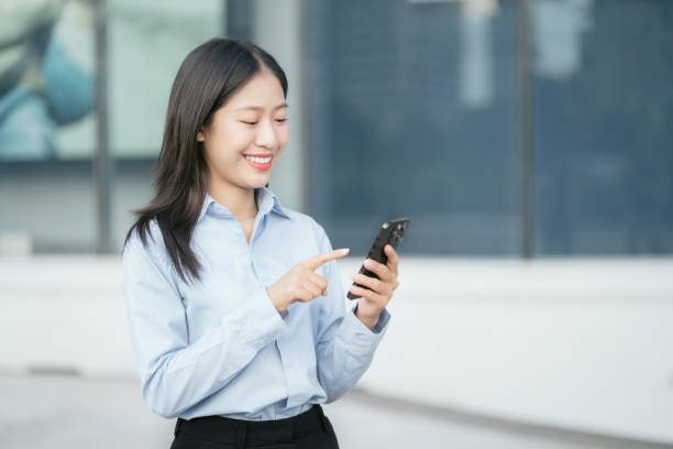 istock Happy young woman smiling while reading smartphone, smiling businessman reading text with smartphone with drinking coffee. 1914460310