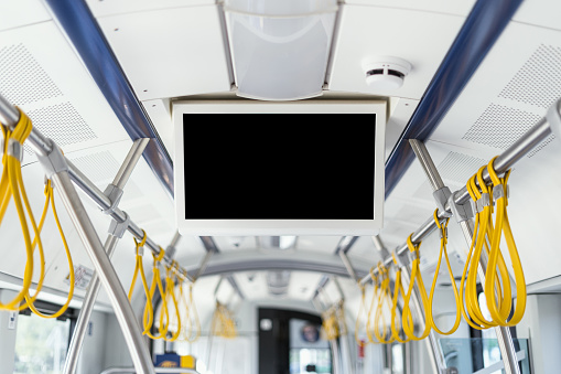 Modern empty tv screen inside bus, train, or tram. Advertising, notification in public transport concept. Showing information for passengers about number and line of route, destination, stops.