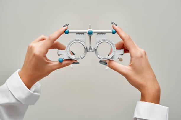 Glasses fitting and eye examination by an ophthalmologist stock photo