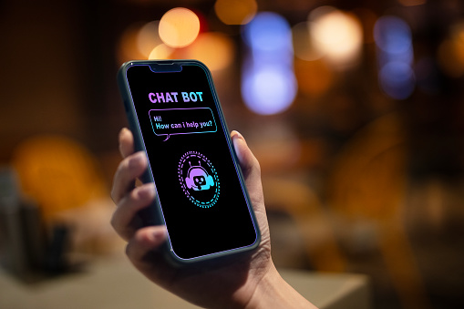 Close-up woman using smartphone chatting with AI chatbot