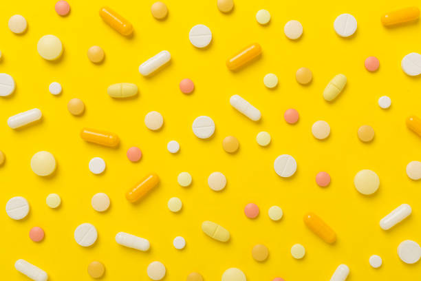 istock Flat lay with different medical pills and capsules on color background 1914534880