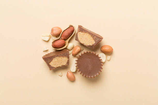 istock Tasty chocolate peanut butter cups on color background, top view 1914535390