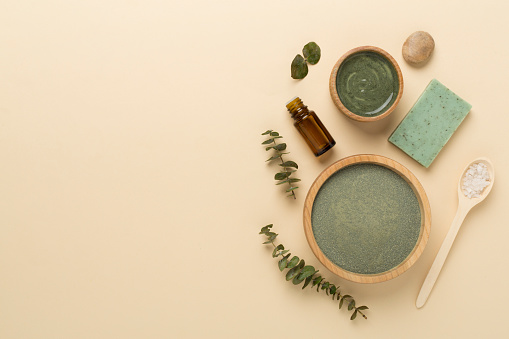 Composition with cosmetic clay and spa products on color background, top view