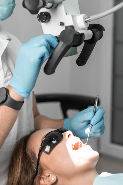 Passionate about his profession, the dentist in his office uses a microscope to accurately identify and treat dental problems. Every moment is a touch of master who works for benefit patients' health.