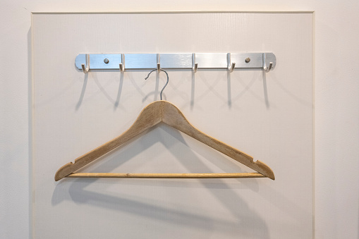 A clothes hanger hanging on the wall