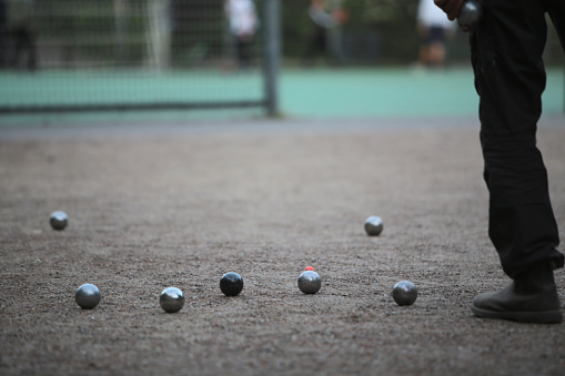detail image of people playing boules in a park