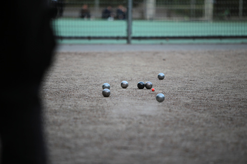 detail image of people playing boules in a park