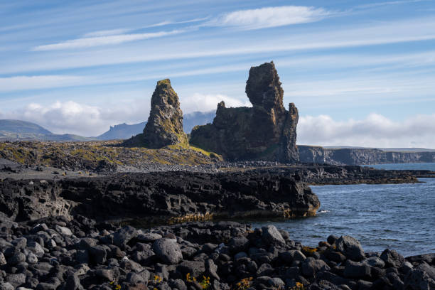 Lóndrangar volcanic cliffs at south coast of Snæfellsnes Peninsula, Iceland Lóndrangar volcanic cliffs at south coast of Snæfellsnes Peninsula and part of Snæfellsnes National Park, Iceland peninsula stock pictures, royalty-free photos & images