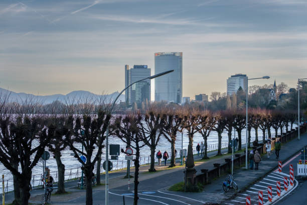 Bonn, Germany - December 17, 2023 : Panoramic view of the promenade next to the river Rhine and the United Nations Campus and the Post Tower in the background in Bonn
