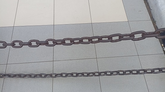 Black thick steel chain. Chain for fencing. Close-up.