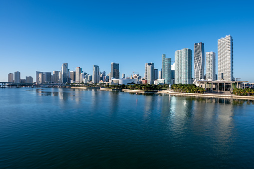 City of Miami, Florida reflected in calm water of Biscayne Bay on sunny December morning.