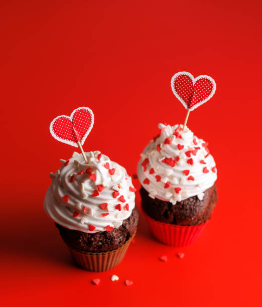 istock Cupcake love: Heart-themed treats on a vibrant red backdrop 1914715882