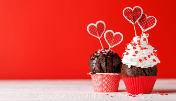 istock Cupcake love: Heart-themed treats on a vibrant red backdrop 1914716413
