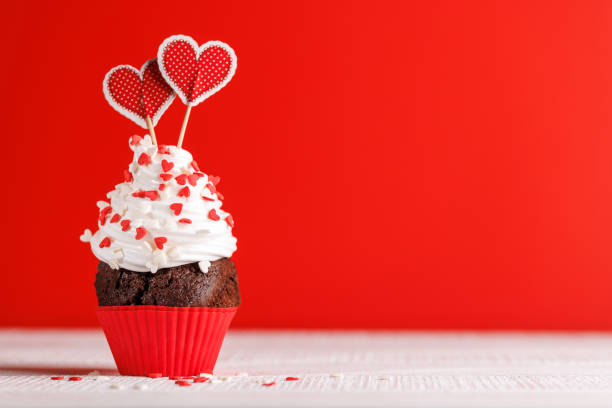 istock Cupcake love: Heart-themed treats on a vibrant red backdrop 1914716934