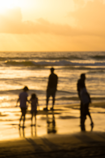 Indian family walking on Goa beach