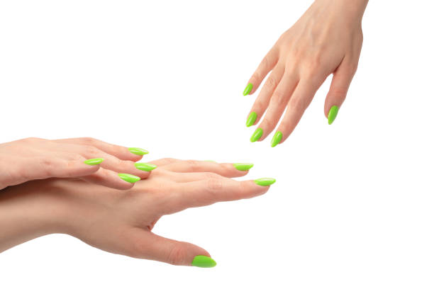istock Hand of a woman with green naols hold some tiny or thin object. 1914758760