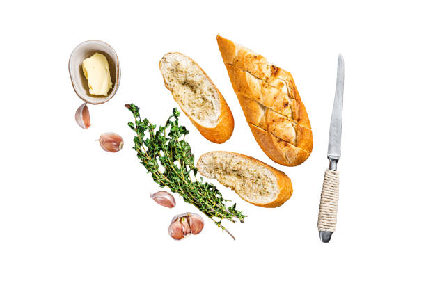 Sliced bread and herb butter dip on a tray, ready to be served with a meal