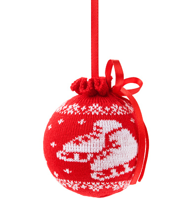 Christmas red ball with skate pattern made of knitted fabric isolated on white. Design detail for postcard.