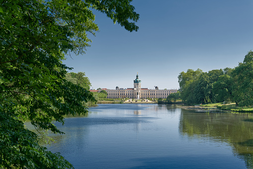 Berlin, Germany - June 01, 2023: Charlottenburg Palace in Berlin seen from a public footpath by the carp pond