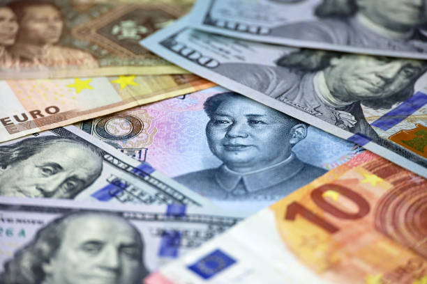 istock US dollars, Chinese yuan and Euro banknotes 1914928827