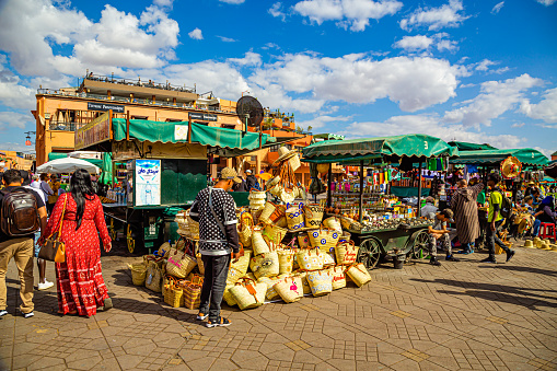 Portrait of male farmer holding a crate full of strawberries at the marketplace.