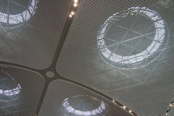 istock Istanbul airport ceiling with rounded abstract lamps, elegance sophistication. Modern fashionable design of large building, halls, creating a feeling of spaciousness and air. Gray-white plates 1914977195