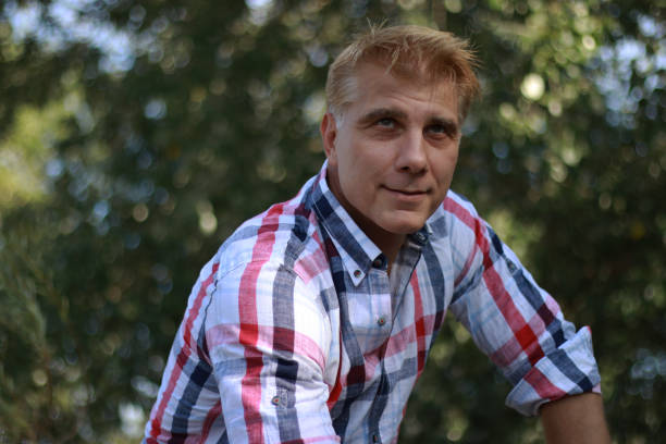 istock Portrait of mature blonde man while sitting on wall 1914990939