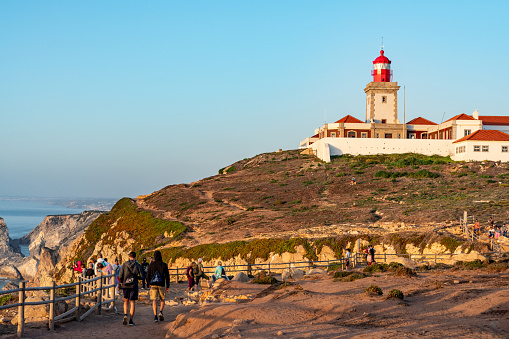 Tourists are enjoying sunset at Cabo da Roca, Westernmost Point of Continental Europe, Sintra, Portugal.