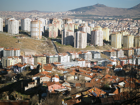 Urban transformation in Ankara. Slums and multi-storey modern buildings together. Altindag, Ankara, Turkiye - January 06, 2024: